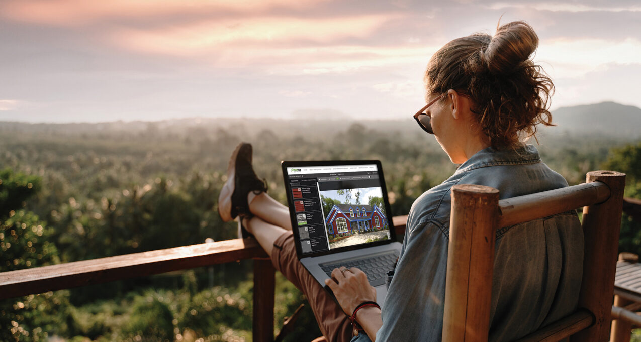 Woman on a laptop outside using ProVia's Design Center home exterior design tools to design home exterior solutions.