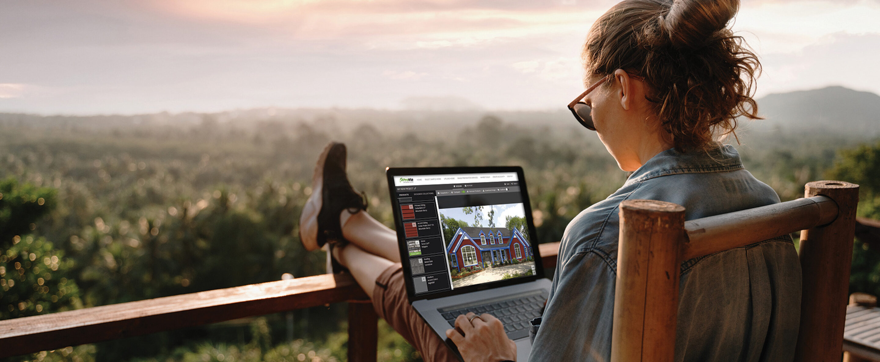 Woman on a laptop outside using ProVia's Design Center home exterior design tools to design home exterior solutions.