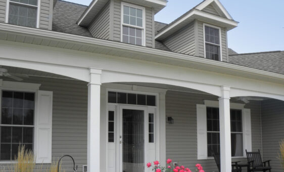 Ultra vinyl lap siding in the color Gray, example of a Cape Cod style home with Cape Cod style front door and windows.