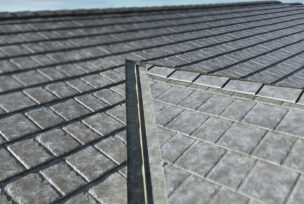 Closeup of a roof with ProVia metal roofing in gray Ironstone Slate