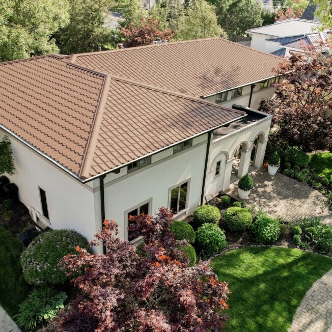 Barrel tile metal roofing in Terracotta on a Spanish-style home