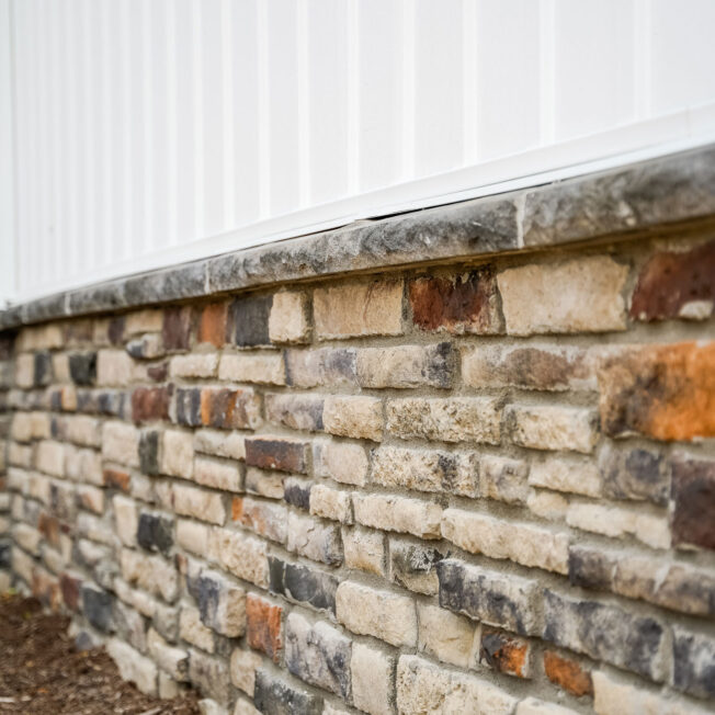 Chisel Cut™ Brindle Manufactured Stone knee wall on a home exterior