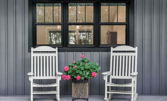 Endure black double hung windows against dark gray board and batten