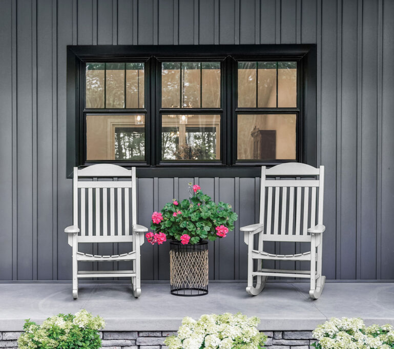 Endure black double hung windows against dark gray board and batten