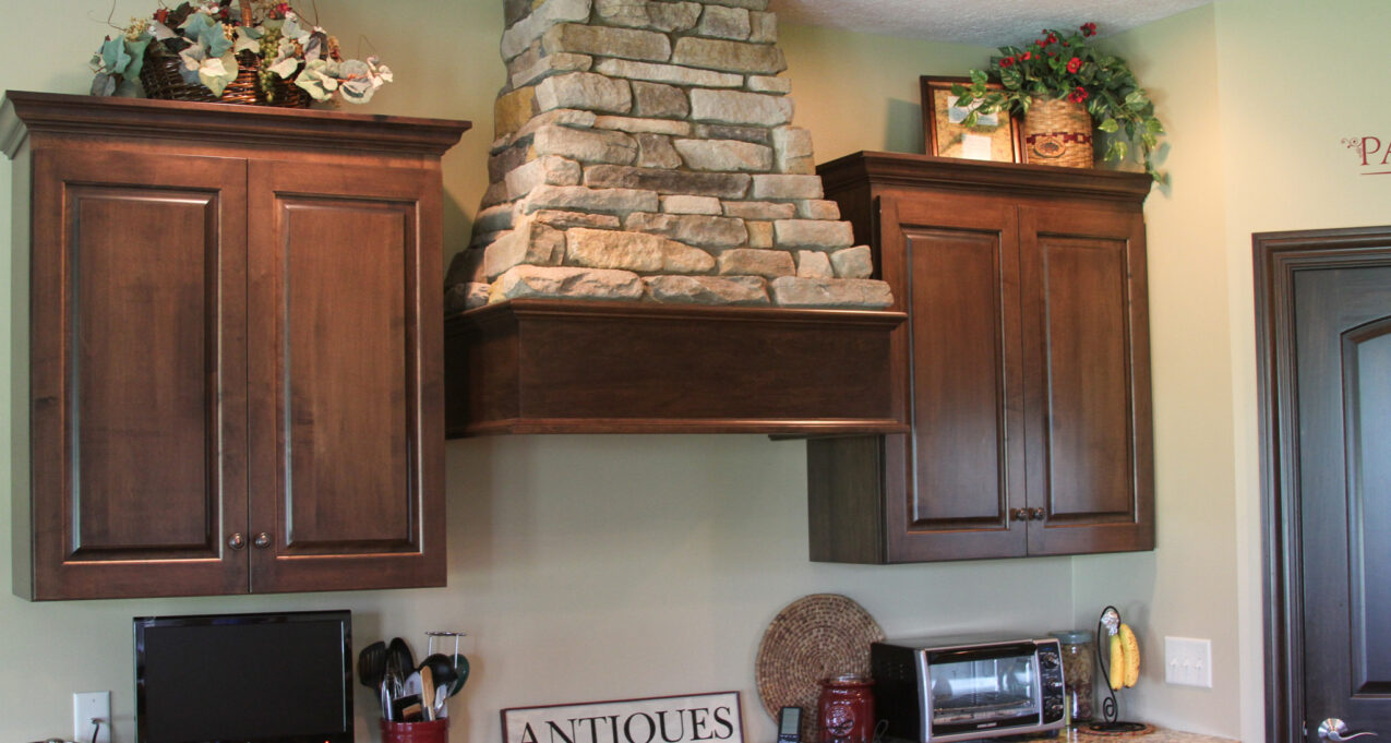 Osage Ledgestone accents in a kitchen on a range vent hood. Manufactured stone is among one of the top value added home improvements.