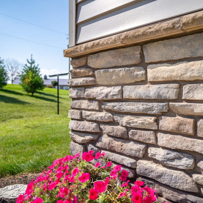 Closeup of Ledgestone veneer in the color Brighton on the foundation of a home