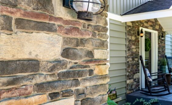 Closeup view of Ledgestone veneer in the color Saginaw, which includes a blend of browns, grays, and reds on a home exterior