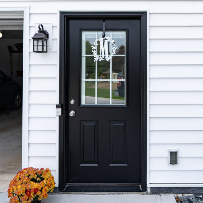 Legacy™ Steel Coal Black painted door with white internal grids on a garage entry, but excellent idea for front doors painted black