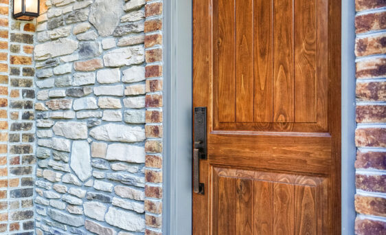 Closeup of a Signet® 002CP 449 entry door in Caramel stain with a painted entry door frame
