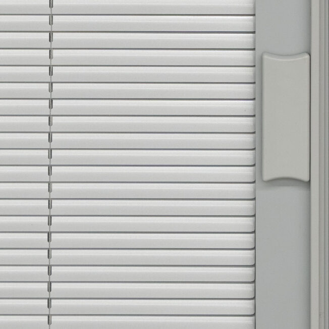 Closeup view of exterior door with blinds in the color Silver