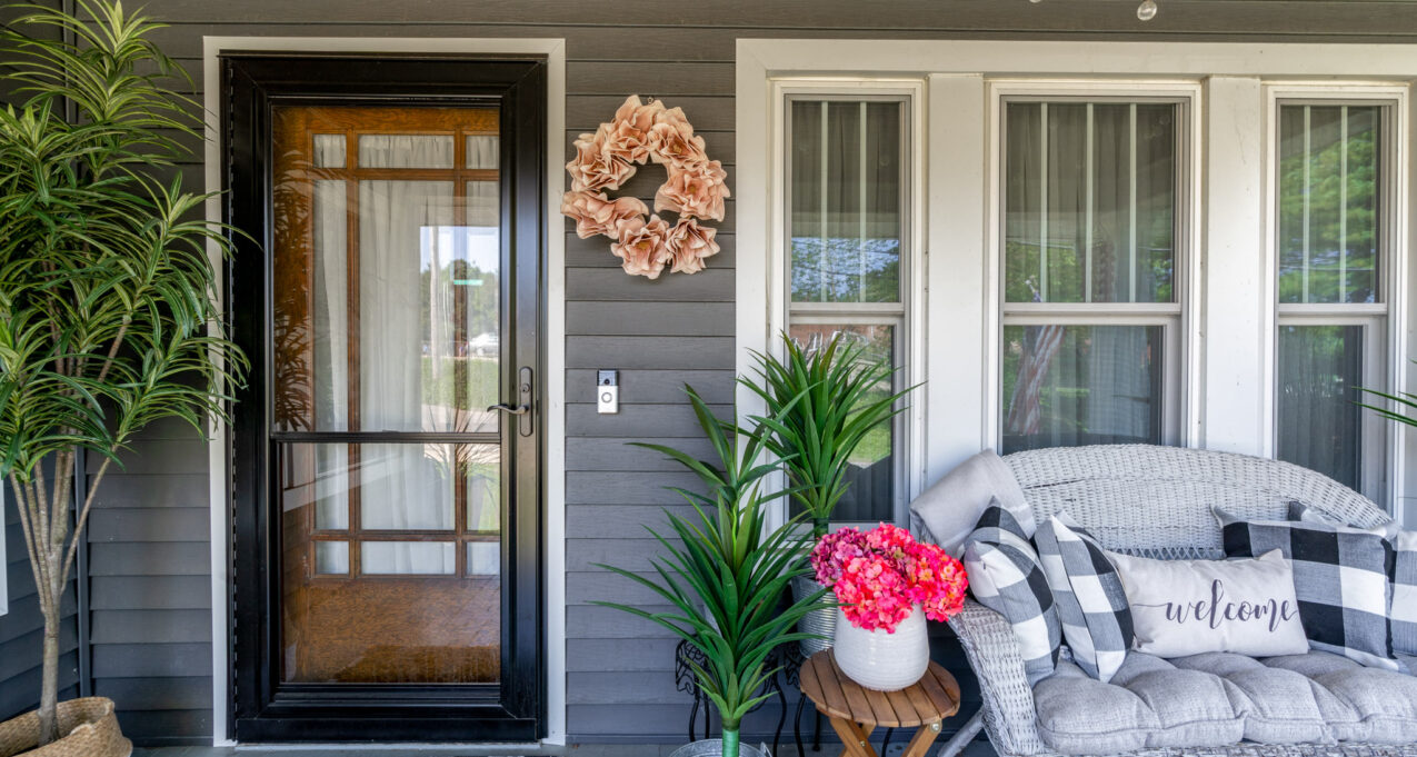 One of ProVia’s Spectrum full view retractable screen storm doors in Coal Black, example of glass screen doors over an entry door, example of ProVia's exterior replacement doors options