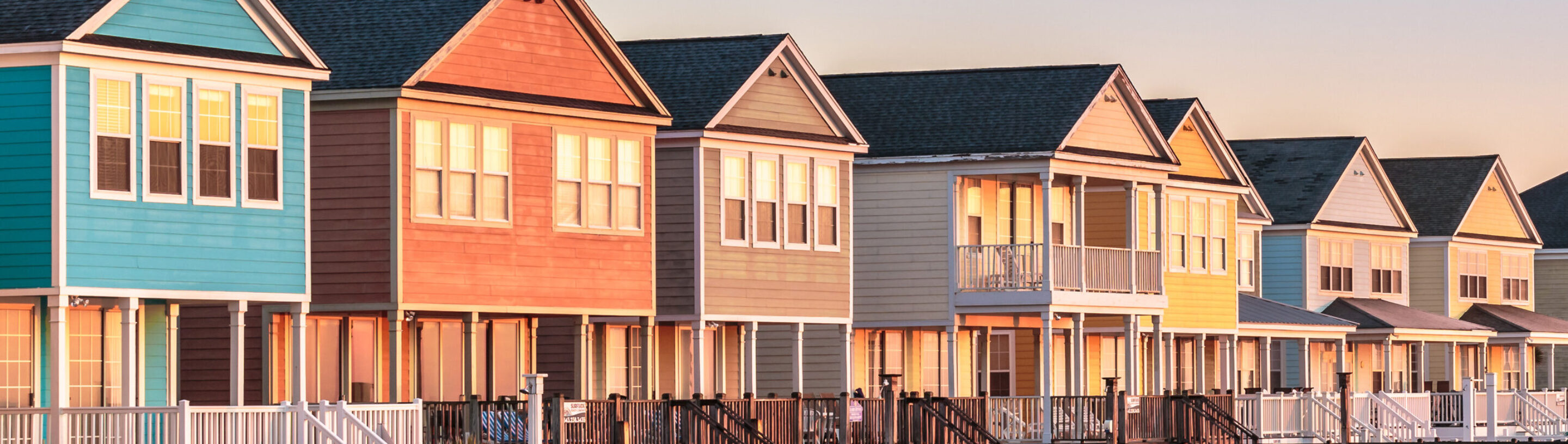 A row of colorful beach houses to illustrate coastal warranty