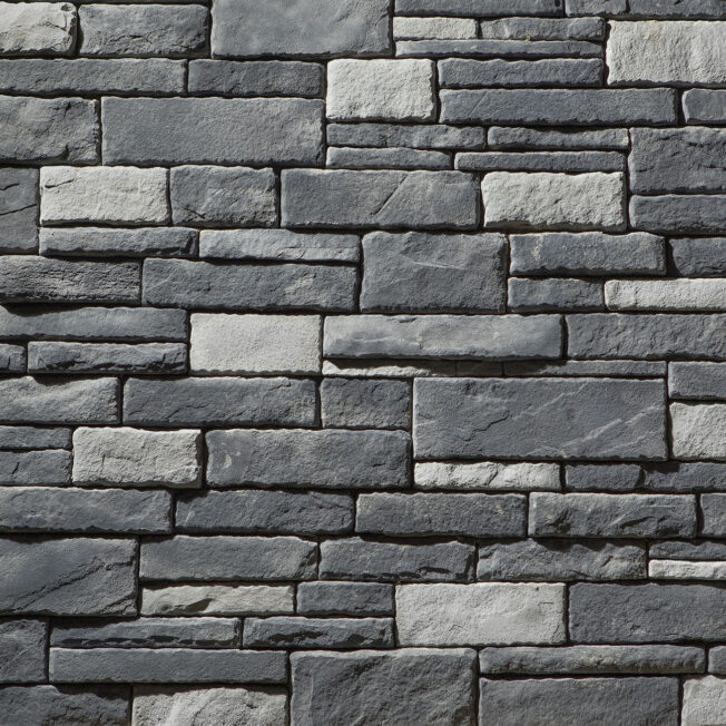 Closeup of manufactured dry stack stone veneer in a color called Erie, which is a mix of light and dark gray stone