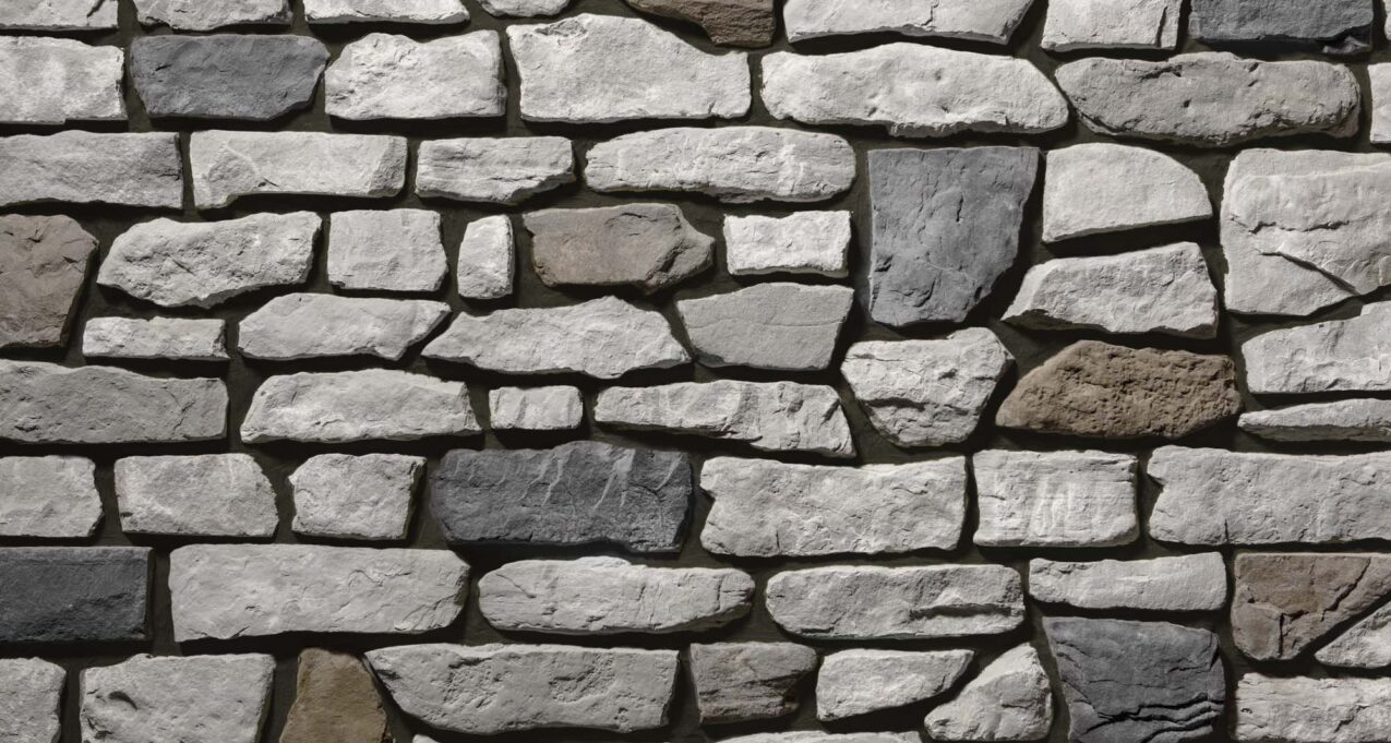 Gray and brown manufactured stone veneer with brown grout, Ridge Cut™ Denali profile