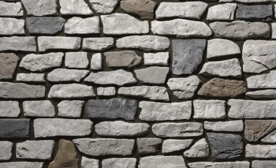 Gray and brown manufactured stone veneer with brown grout, Ridge Cut™ Denali profile