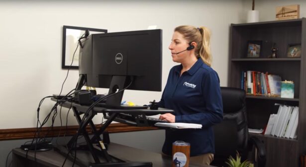 A ProVia customer service representative looks at her computer while on the phone with a customer