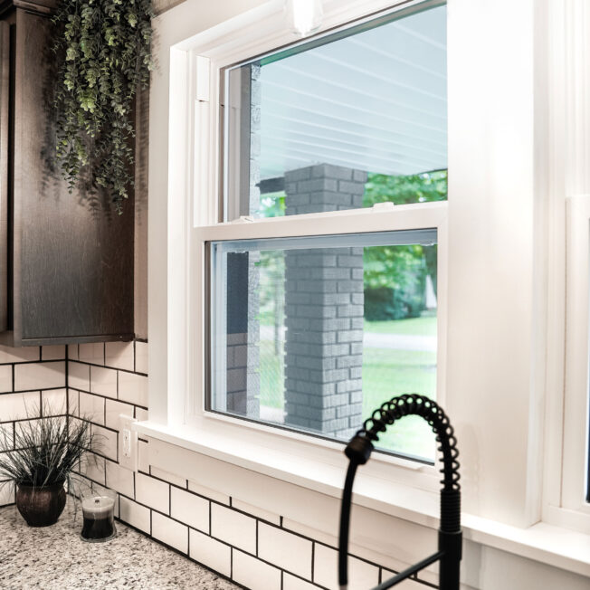 EcoLite white single hung affordable windows in a kitchen with white subwaytiles