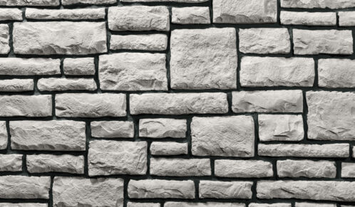 White limestone veneer manufactured stone with black grout, Vail color