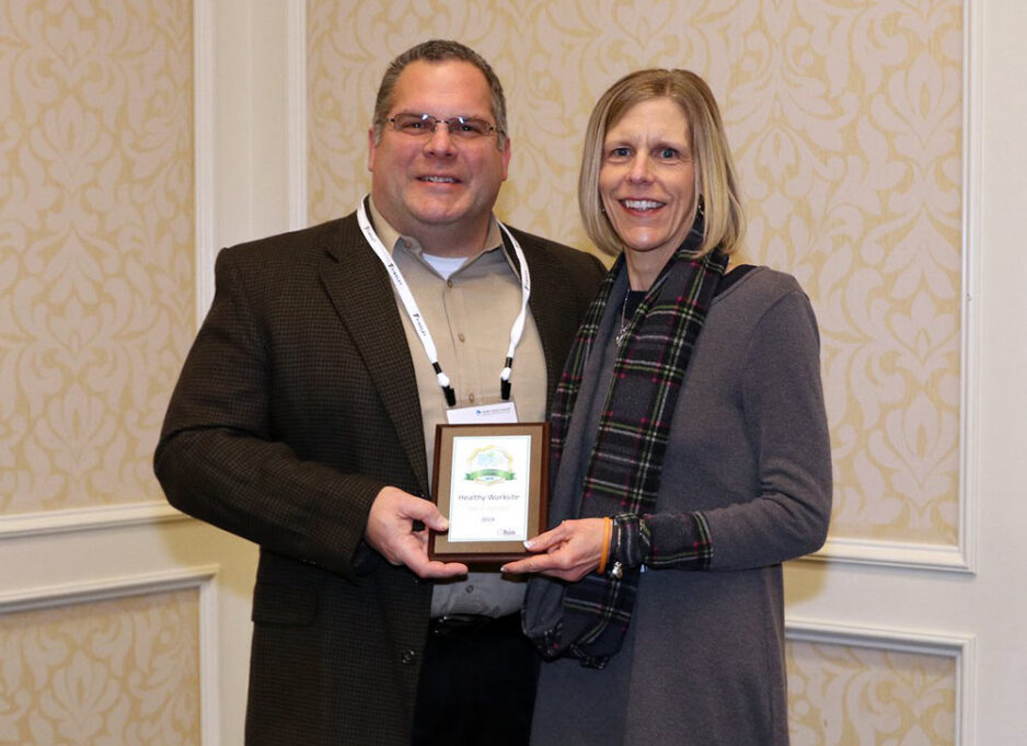 Tricia Hicks (right), Wellness Specialist, accepts 2019 Gold award on behalf of ProVia