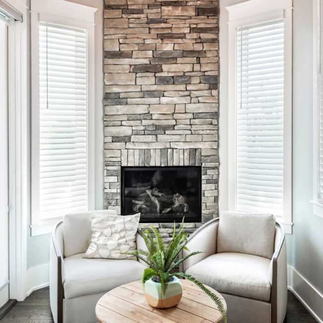 Interior image of a ProVia Terra Cut™ Frost Manufactured Stone floor-to-ceiling Fireplace