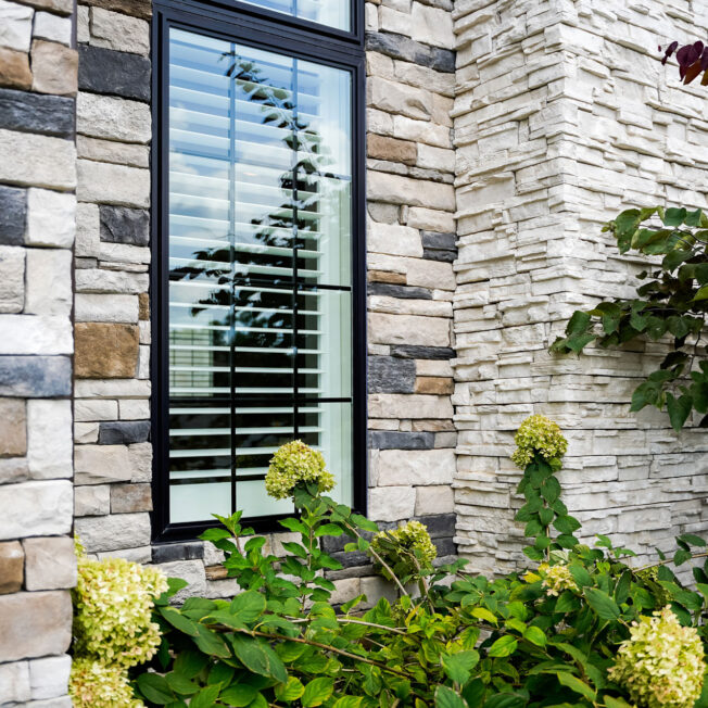 Closeup image of ProVia Terra Cut™ Niagra & PrecisionFit™-Arctic manufactured stone on home exterior