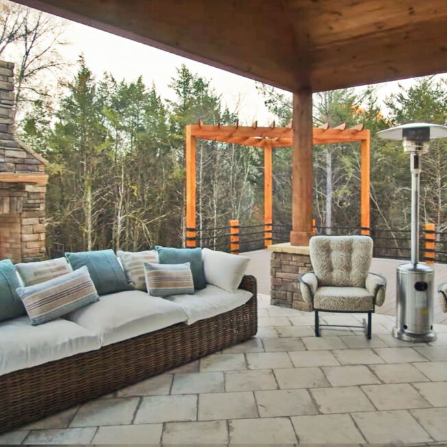 Image of an outdoor patio area with an outdoor fireplace with manufactured stone veneer in Shawnee Dry Stack