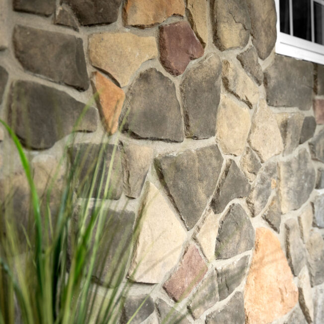 {Closeup photo of ProVia Fieldstone Manufactured Stone in the color Pennsylvania on a home exterior}